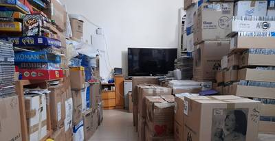 My living room with all my boxes of CDs and children games.